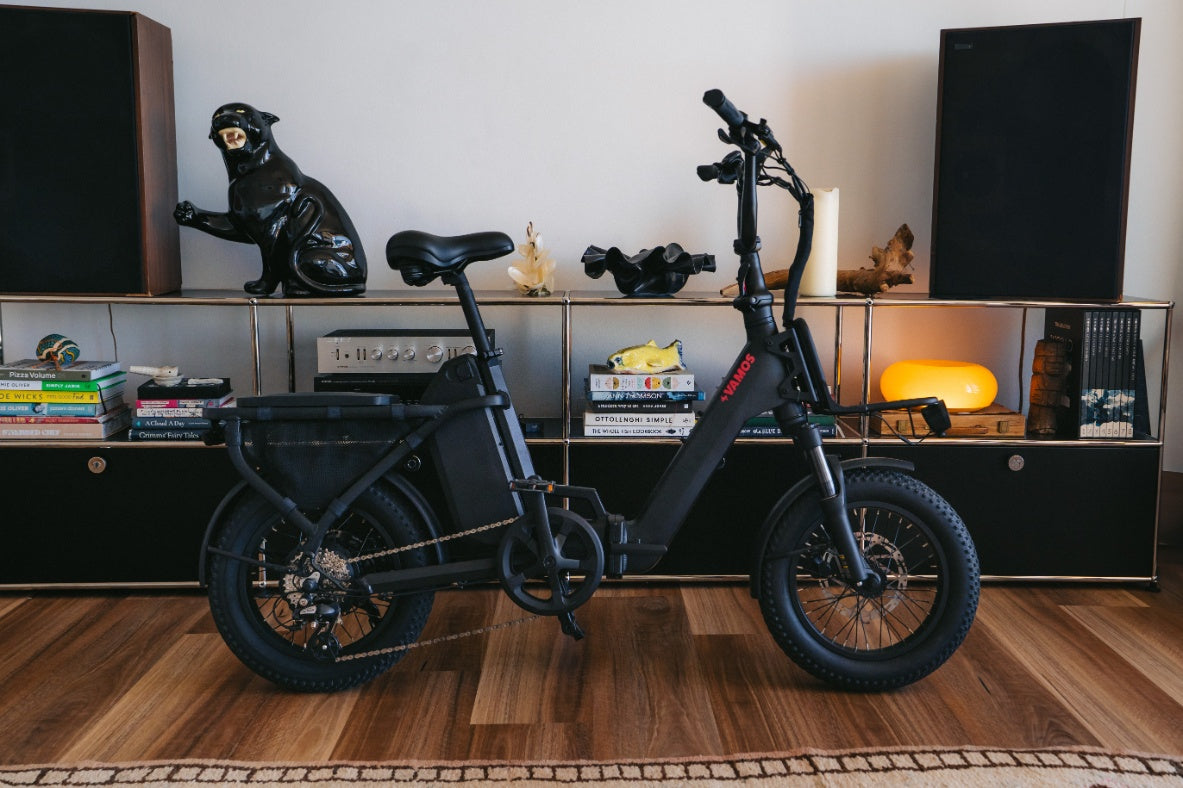 Black electric bike in a room with books and decor