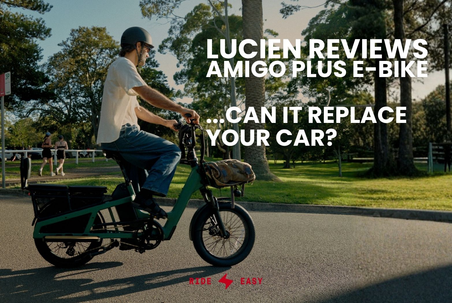 Man wearing a helmet riding a green Vamos El Amigo Plus Commuter Ebike on a paved park path